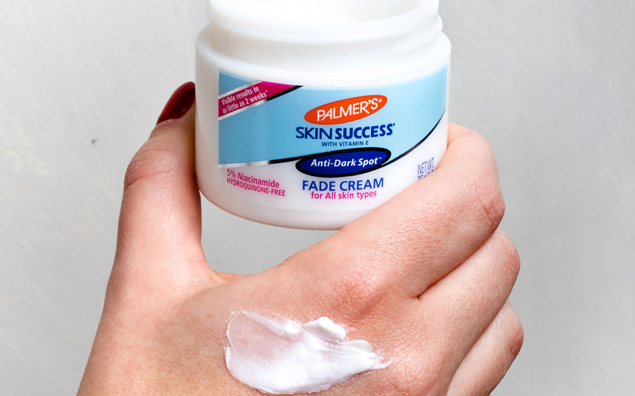 woman holding skin success fade cream swatch on hand